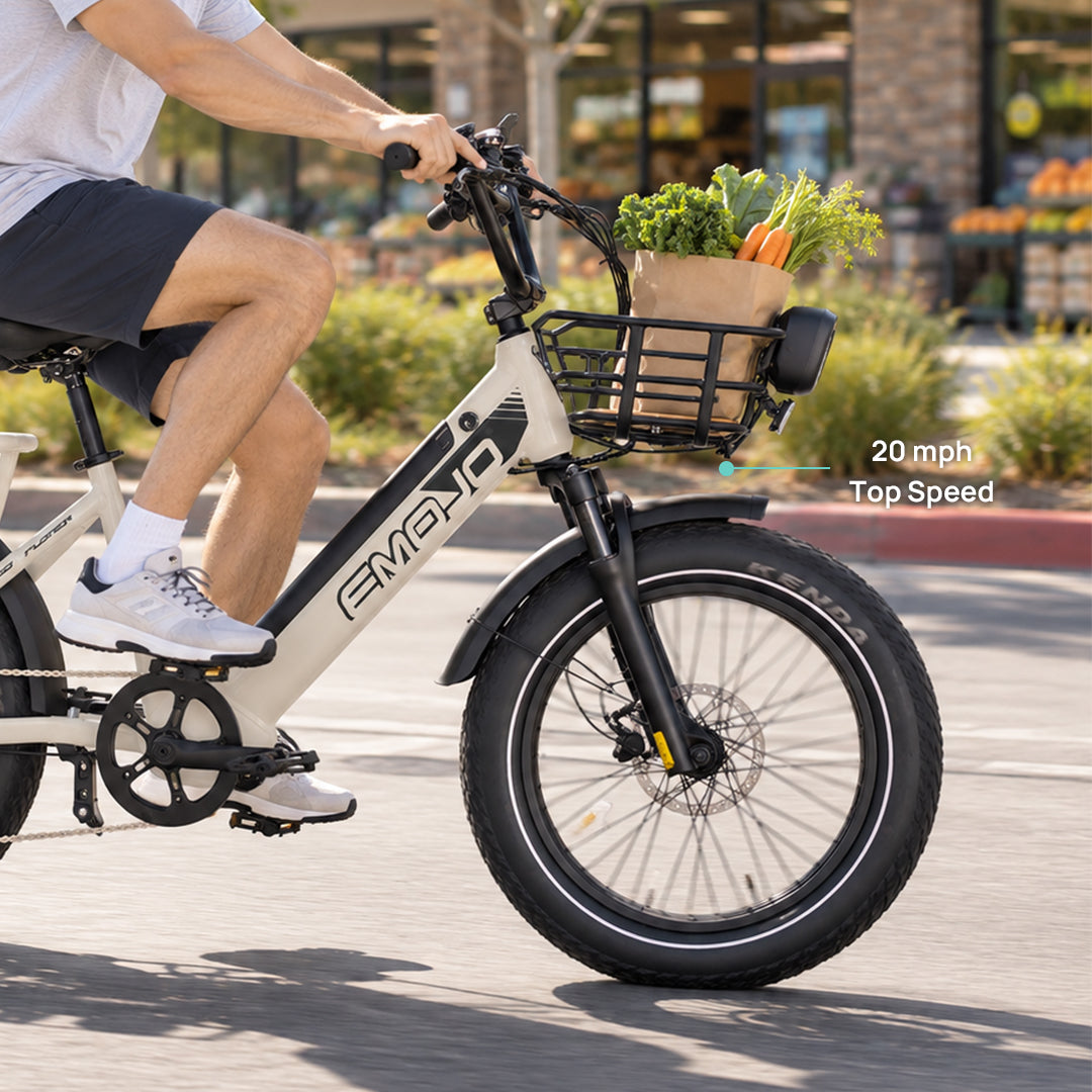 man riding emojo cargo xplorer electric bike with front basket carrying groceries at 20 mph top speed